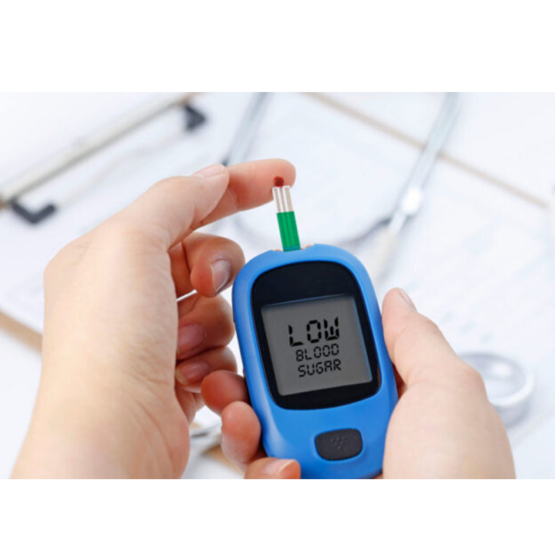 Close-up of a hand holding a glucose meter displaying 'Low Blood Sugar,' symbolizing blood sugar monitoring and diabetes care.