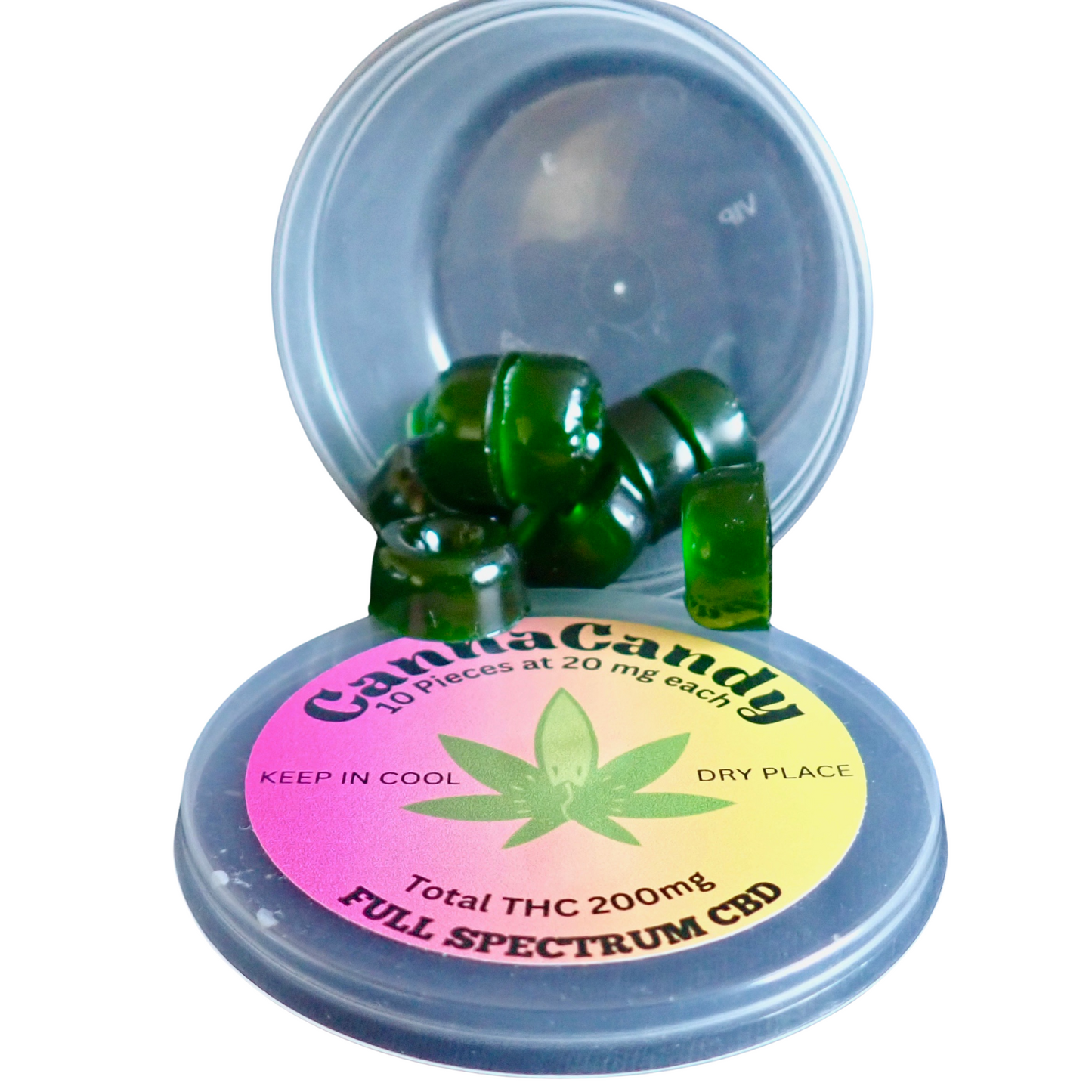 This image shows a plastic container with its lid open. Inside are green, square-shaped candies spilling out. The lid has a colorful label with a cannabis leaf in the center, stating "CannaCandy," "10 pieces at 20mg each," "Total THC 200mg," and "Full Spectrum CBD."






