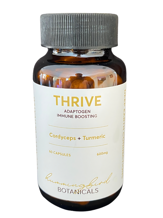 A bottle of Thrive supplement featuring Cordyceps and Turmeric for adaptogenic and immune-boosting support. The label indicates 60 capsules at 600mg from Hummingbird Botanicals.